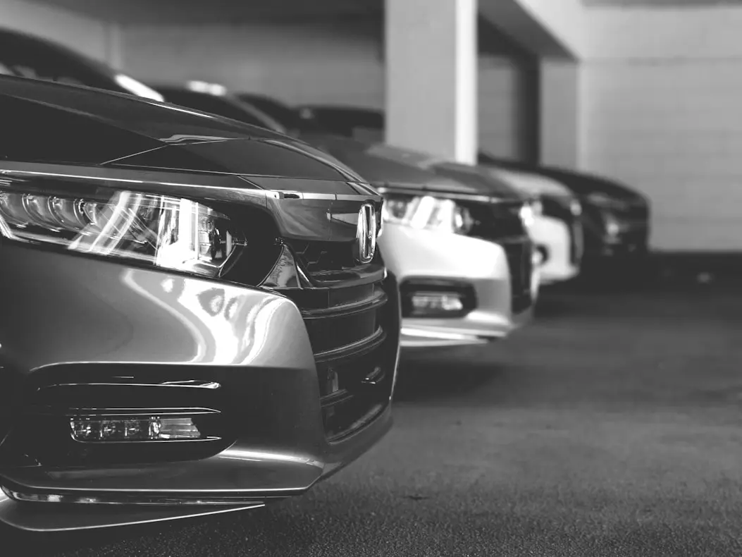 Rental car accident liability concept showing damaged car and insurance documents